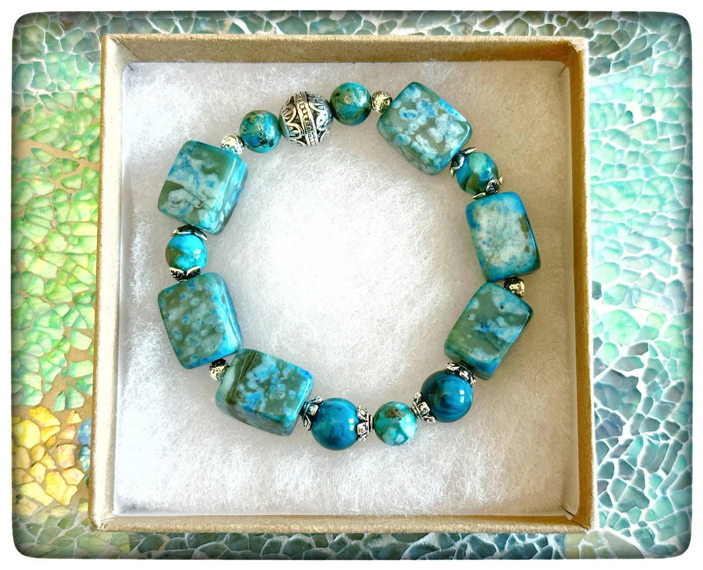 Sea-green bracelet with large irregular beads and small metallic accents