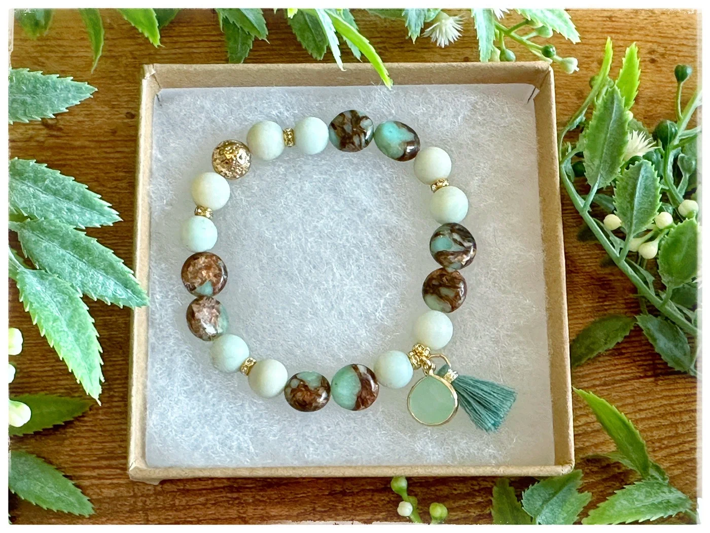 An original cream and green bracelet with a leaf-shaped detail